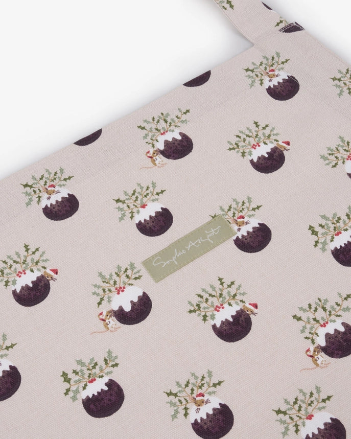 Fabric apron with a repeating Christmas puddings pattern on a white background