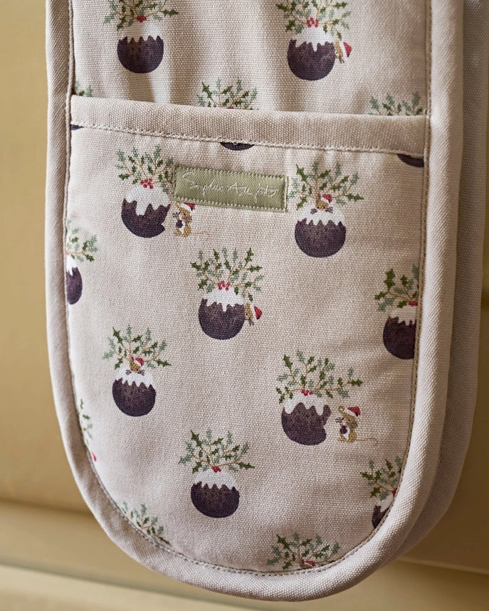 A cream-colored oven mitt with a repeated Christmas pudding pattern, on a white background