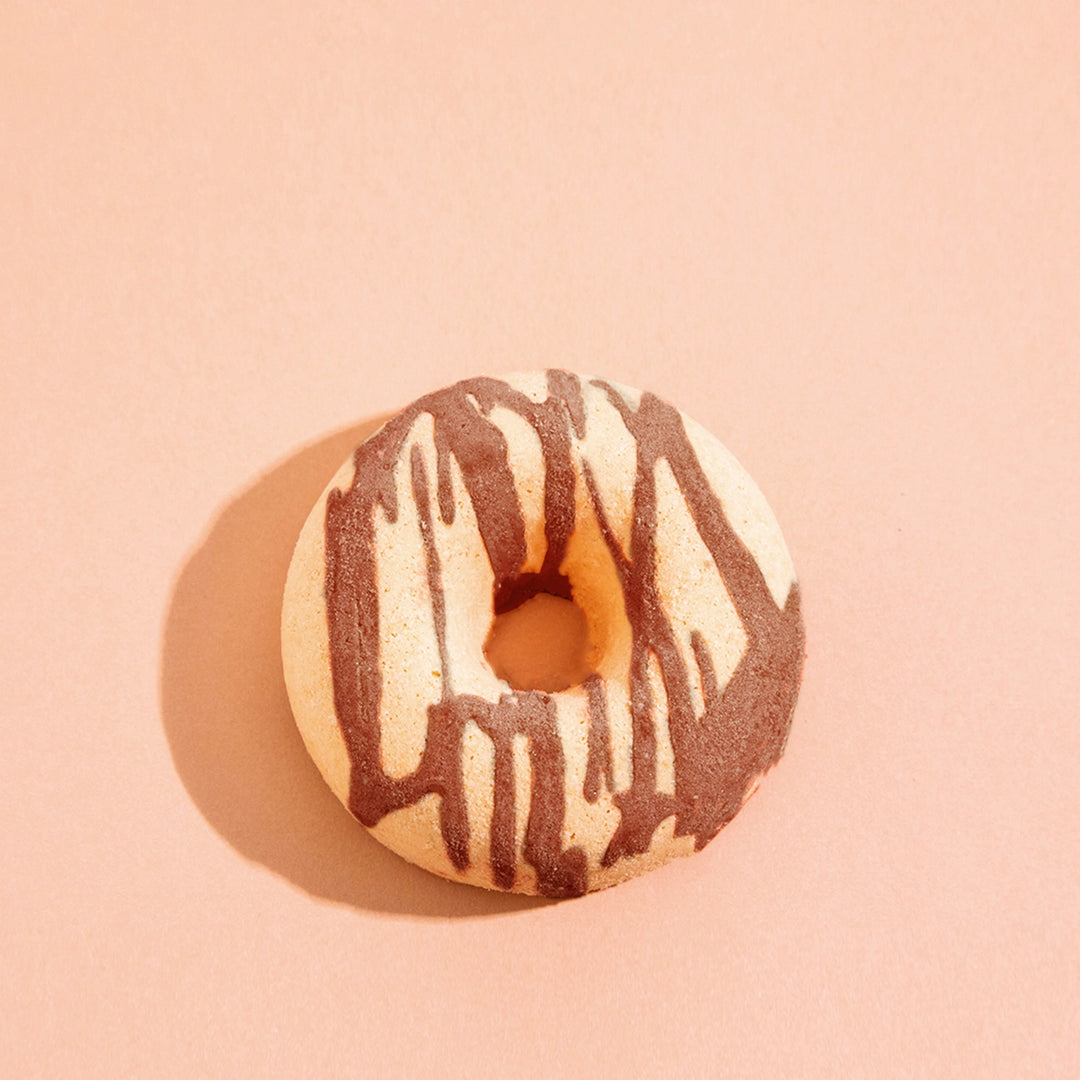 Donut bath bomb on a pink background