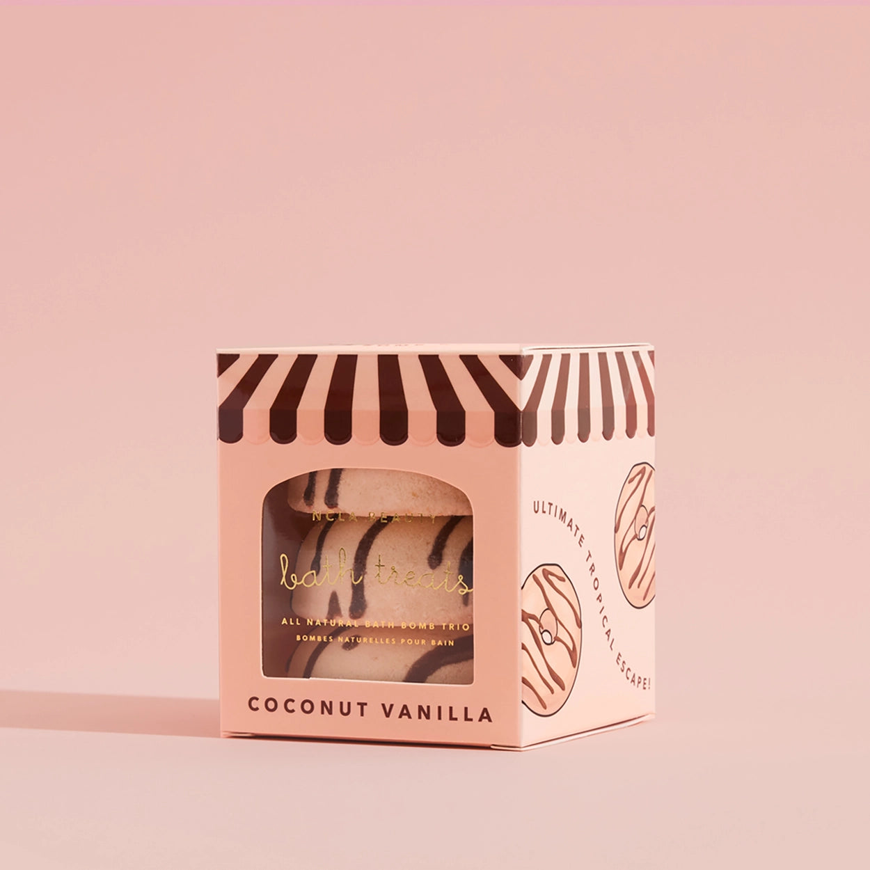 Coconut vanilla bath bomb packaging on a pink background
