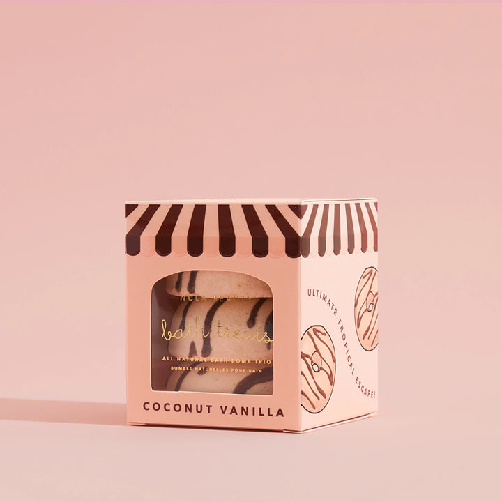Coconut vanilla bath bomb packaging on a pink background