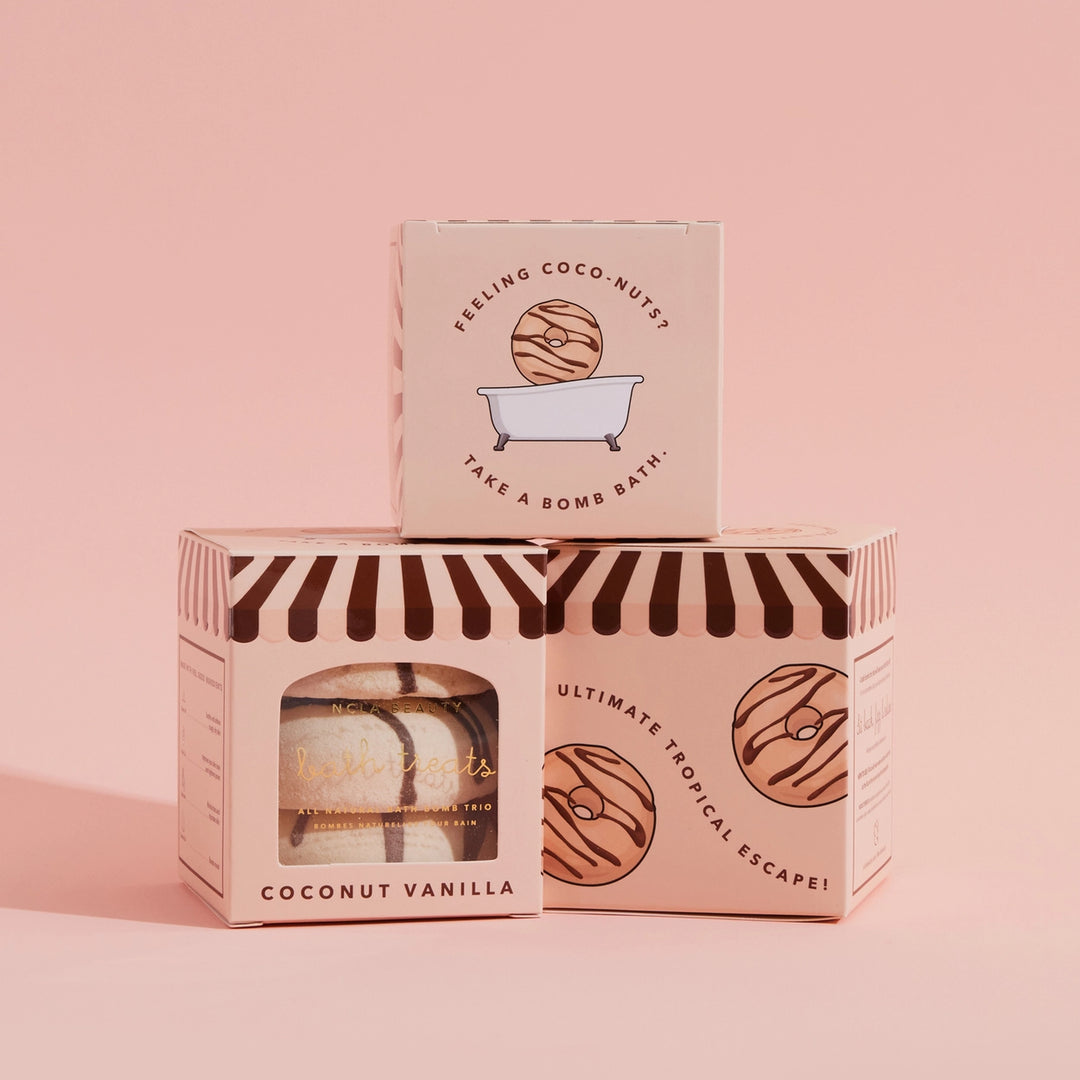 Bath bomb packaging with striped design on a pink background