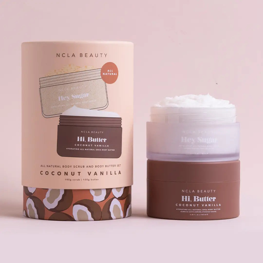 NCLA Beauty coconut vanilla body scrub and body butter on a light pink background