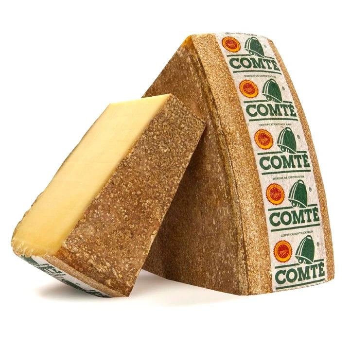 Triangle-shaped Comte cheese with a visible label on a white background