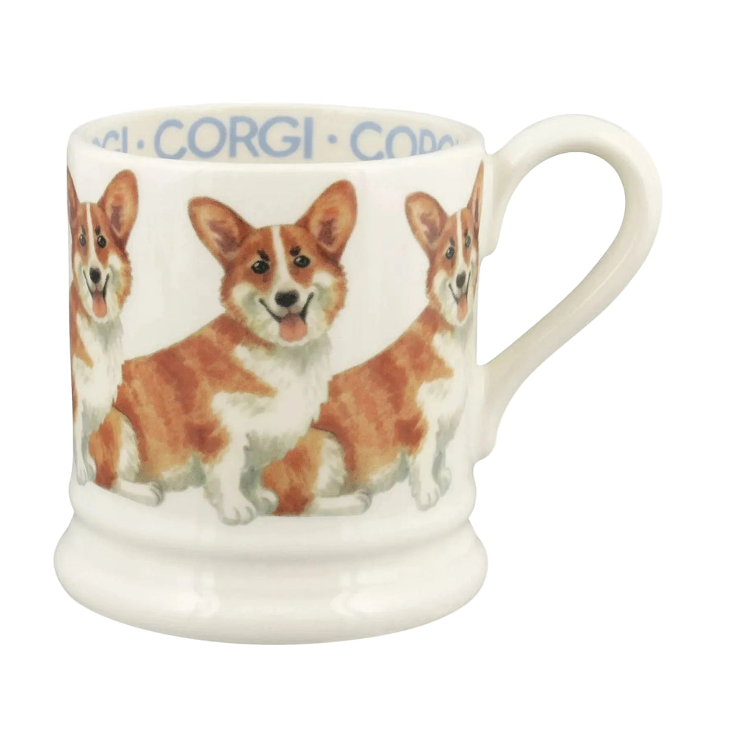 A white ceramic mug featuring illustrations of Pembroke Welsh Corgi dogs, with the word &