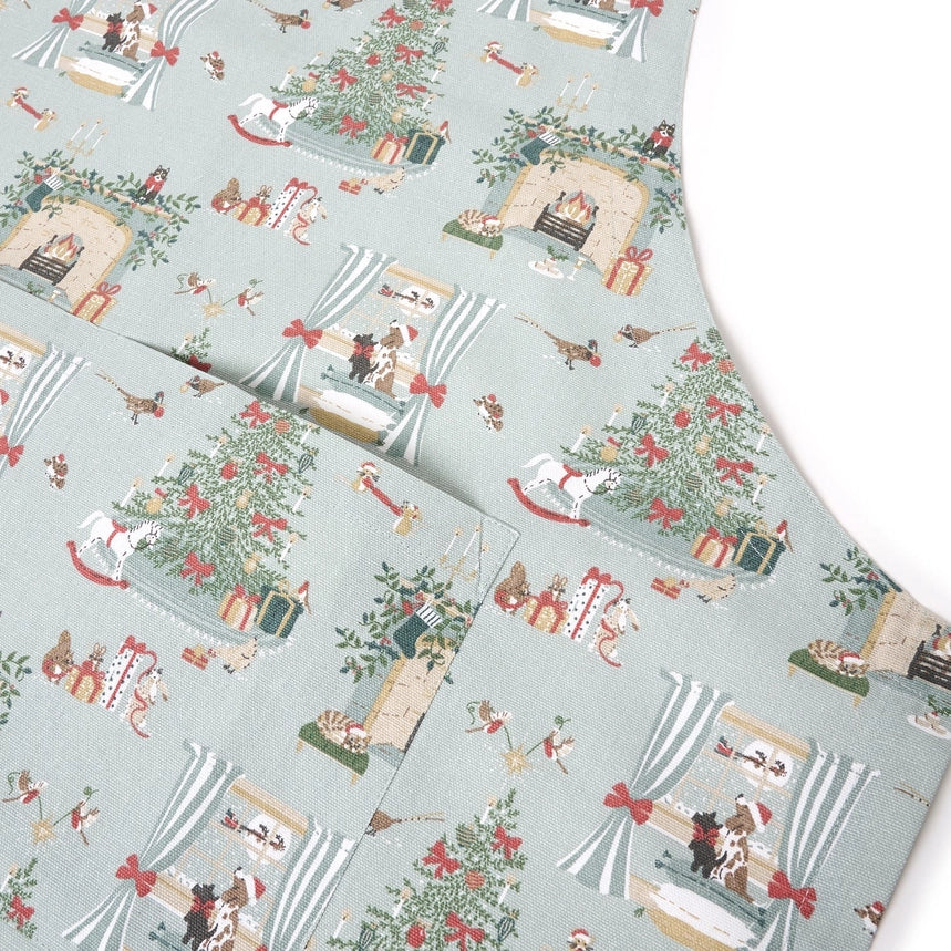 Apron with a detailed holiday fireplace illustration pattern on a white background