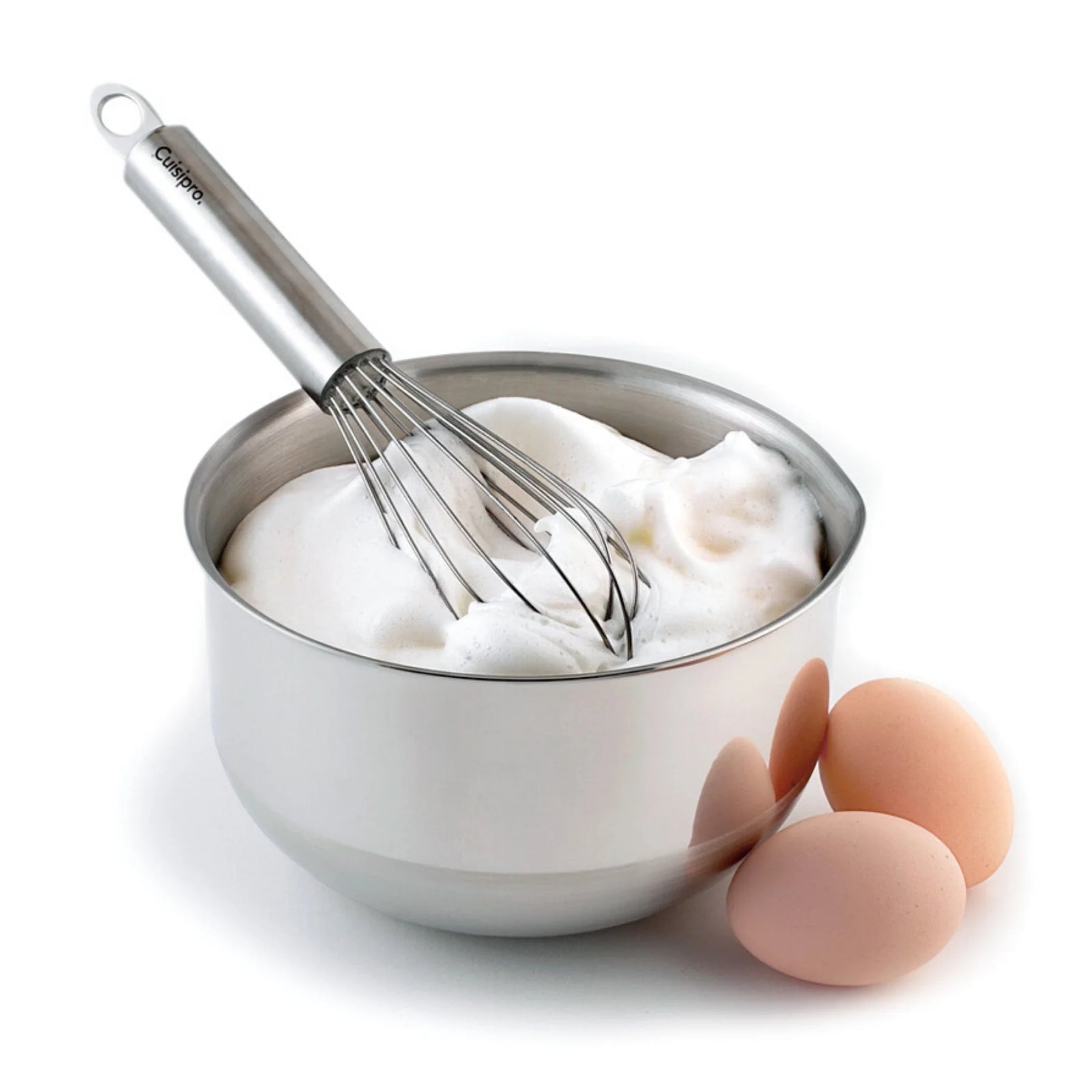 Metal mixing bowl with whipped egg whites and a whisk, next to two eggs on a white background