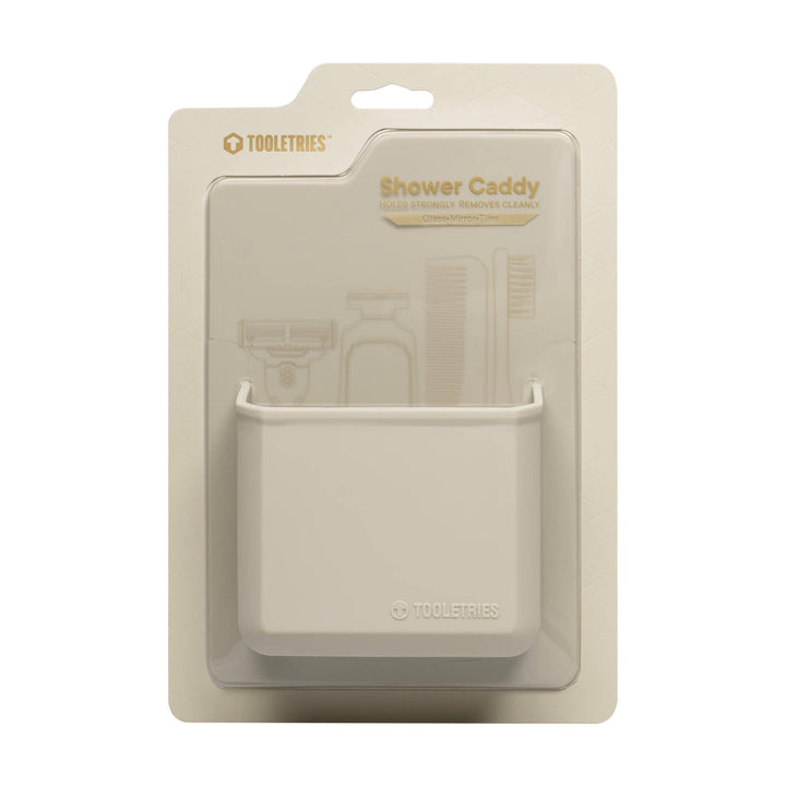 Sand coloured shower caddy with packaging on a white background