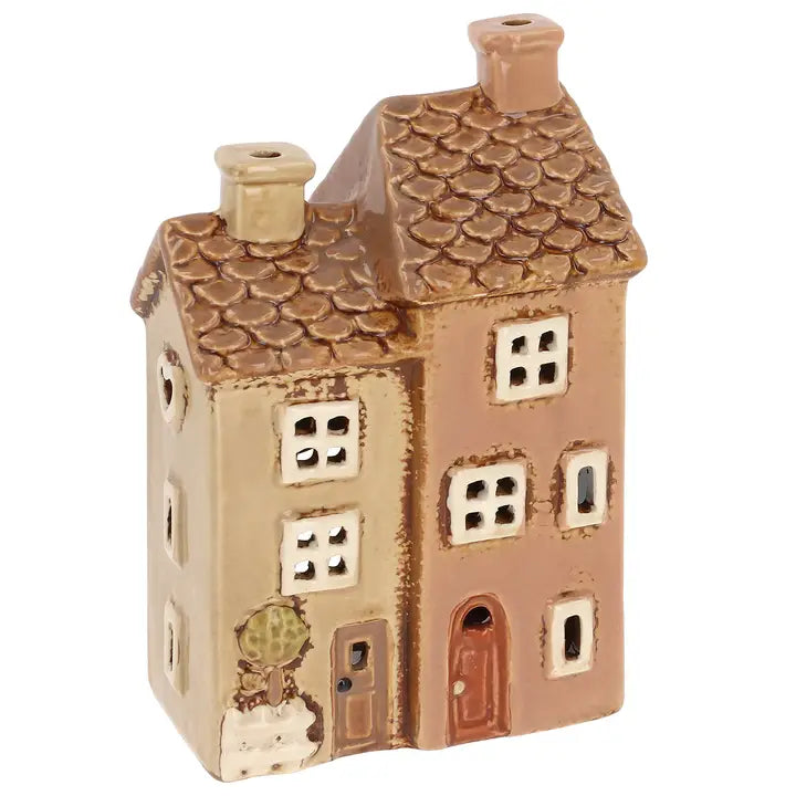 A double terrace ceramic house tealight holder on a white background