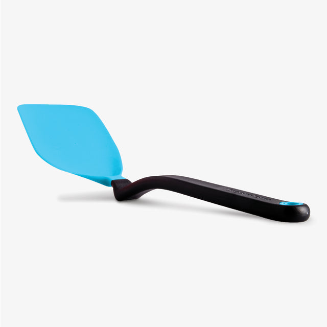 Blue spatula with black handle on a white background