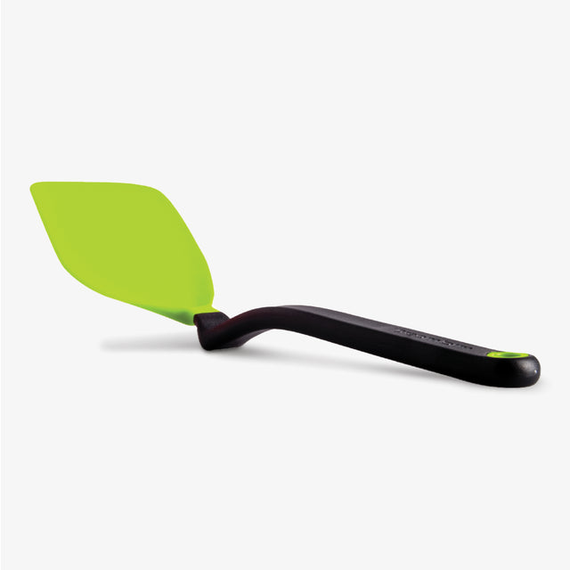 Green spatula with black handle on a white background