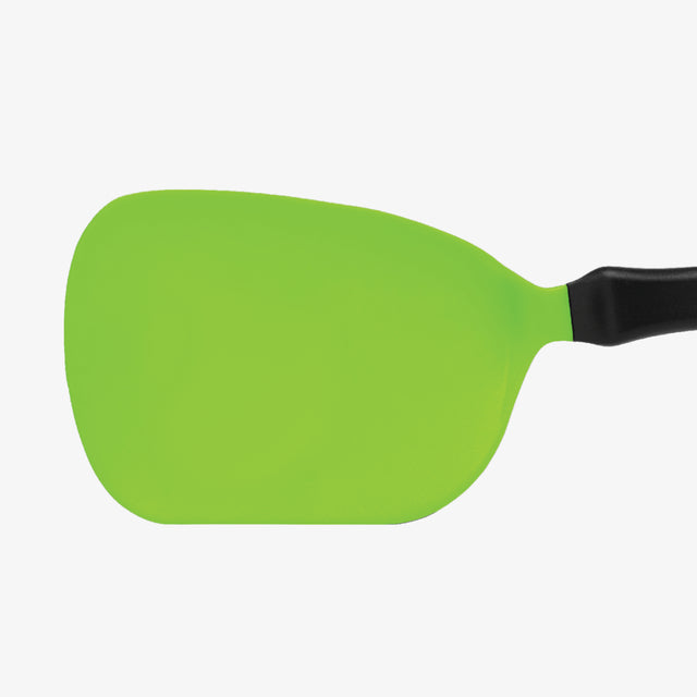 Green plastic spatula with black handle on a white background