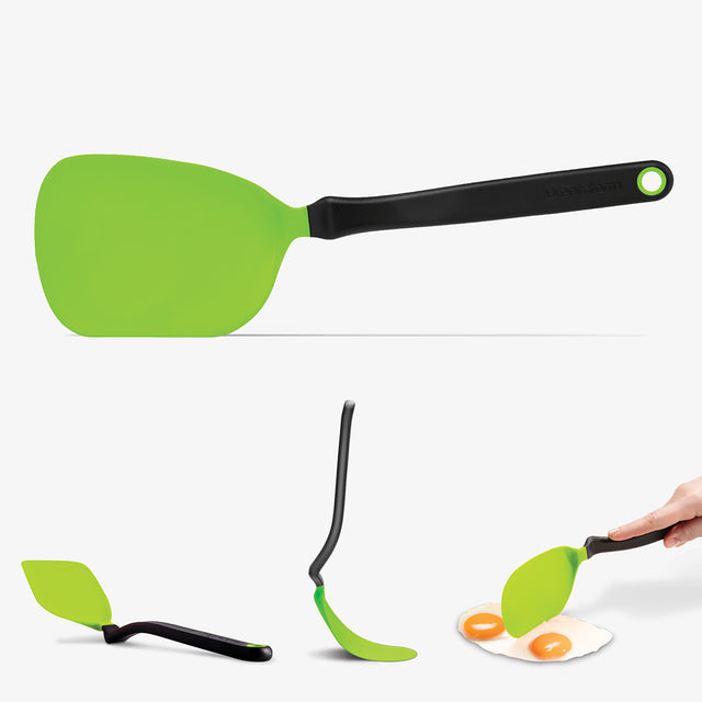Green spatula with black handle on a white background