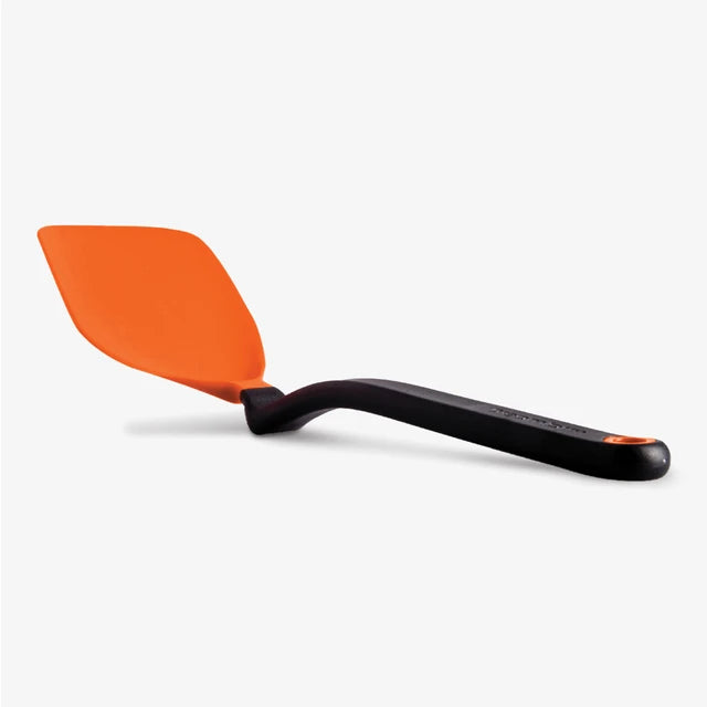 Orange spatula with black handle on a white background