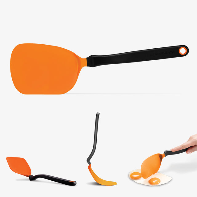 Orange spatula with black handle on a white background