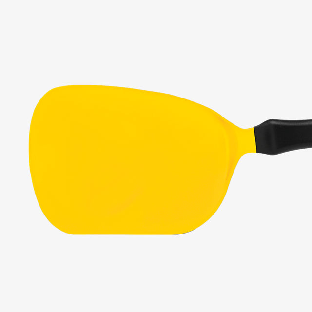 Yellow spatula with a black handle on a white background