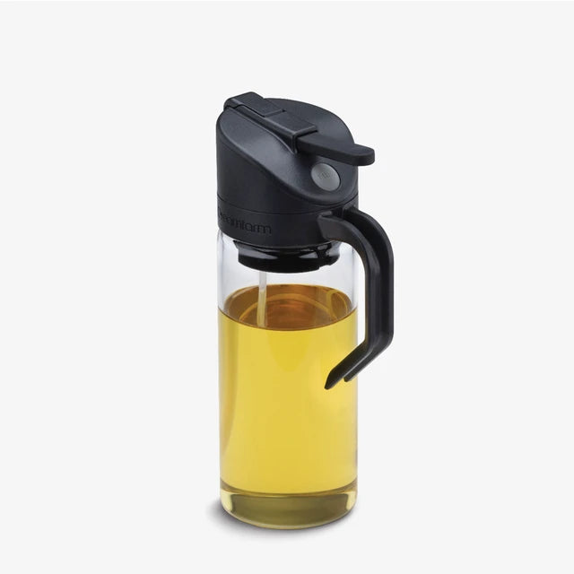 A Dreamfarm glass oil bottle and sprayer on a white background