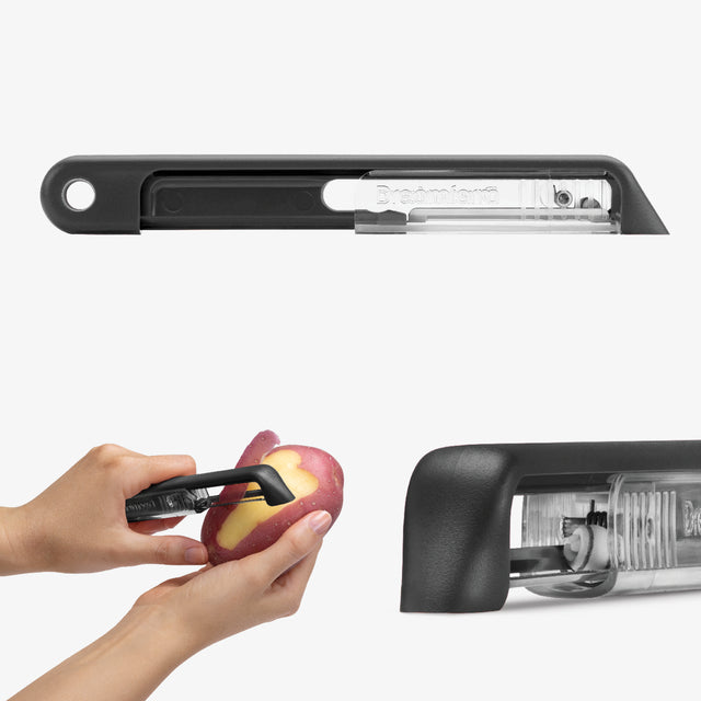 Black vegetable peeler being used to peel a potato on a white background