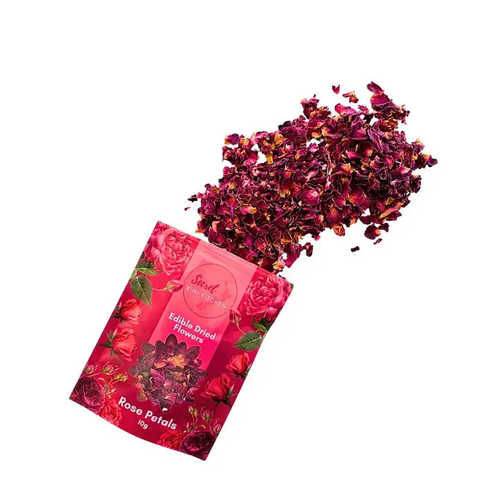 Pink packaging of Edible Dried Flowers with rose petals spilling out on a white background