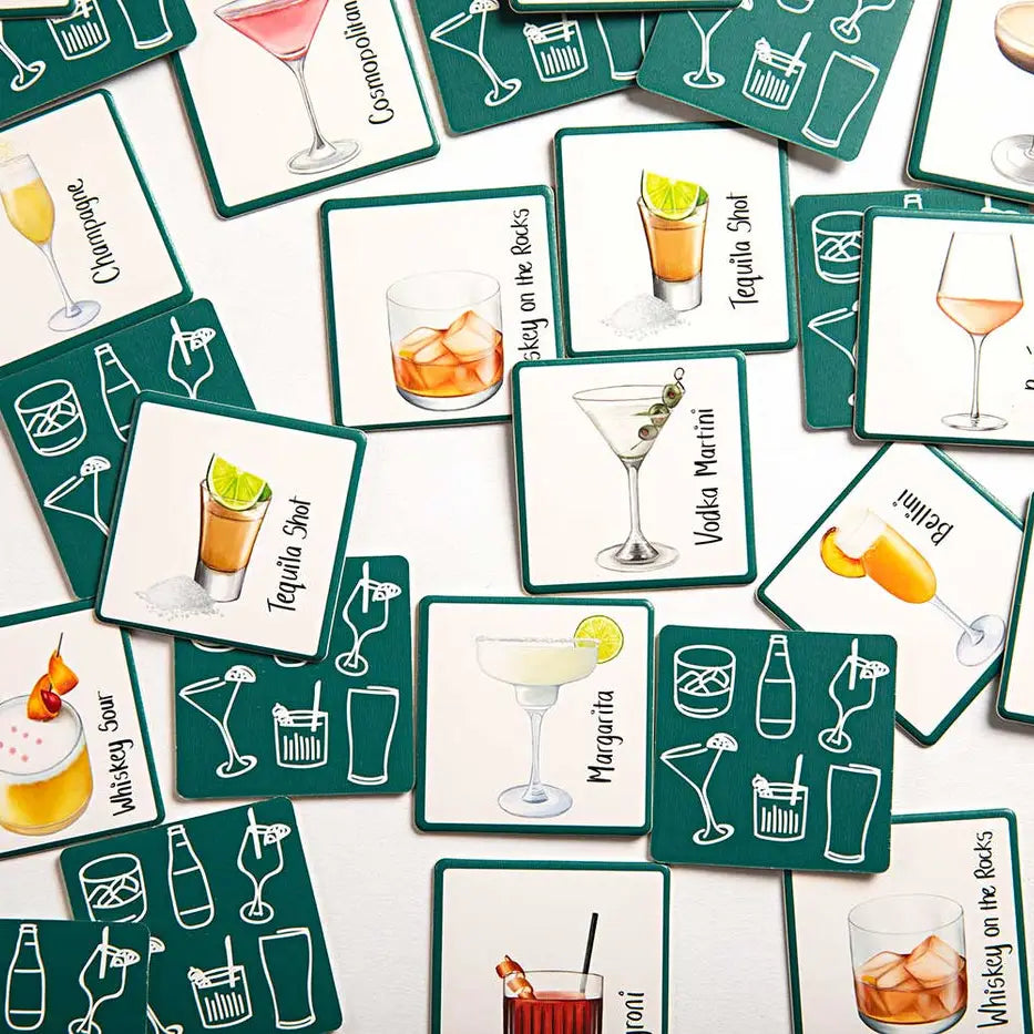 A scattered arrangement of square cocktail-themed cards on a white surface. The cards are dark teal with white borders and feature illustrated drinks, glassware, and cocktail names such as Cosmopolitan, Tequila Shot, Margarita, and Whiskey on the rocks.