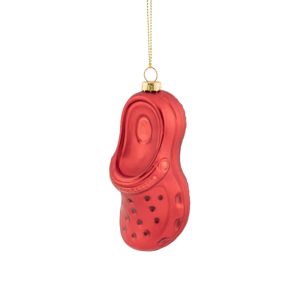 Red glass ornament shaped like a shoe with a gold chain on a white background