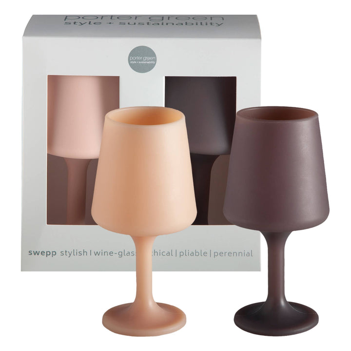 Two wine glasses, one beige and one brown, in front of a packaging box with &