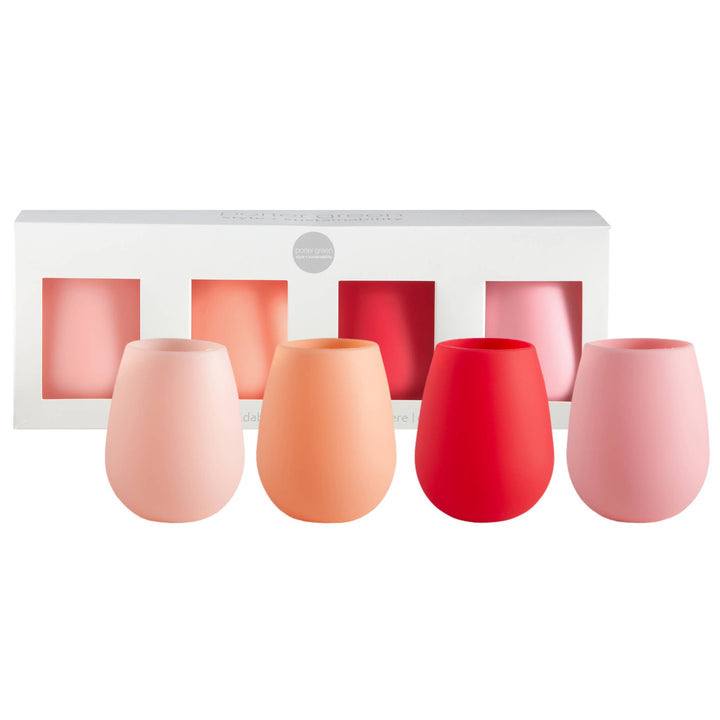 A set of four silicone stemless wine glasses in pastel pink, peach, red, and light pink, displayed in front of their white packaging box.