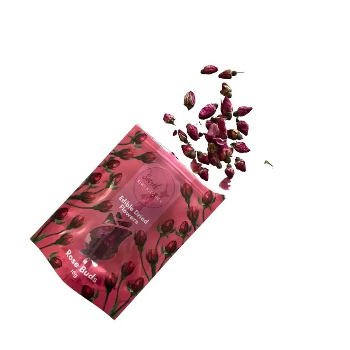 Pink packaging of rose buds with scattered rose buds on a white background