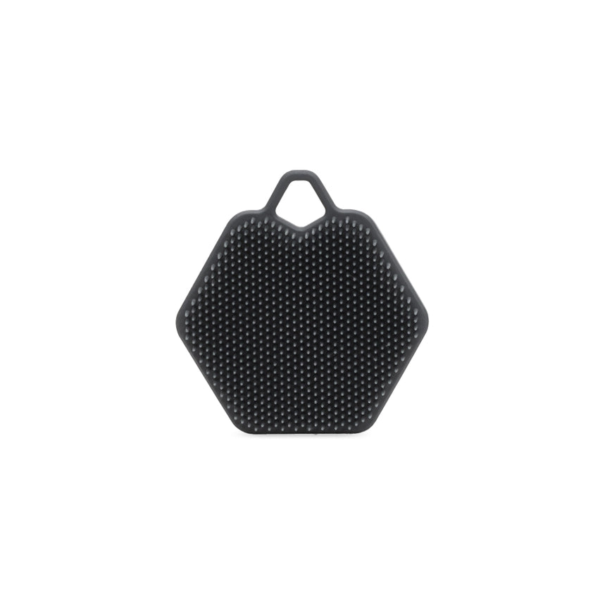 A dark gray hexagonal silicone scrubber with a textured surface and a loop at the top, shown on a plain white background.