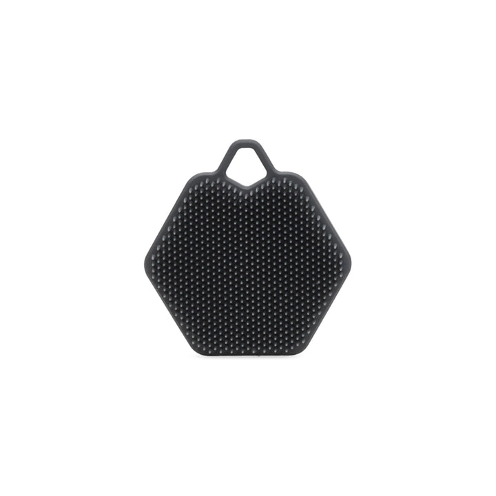 A dark gray hexagonal silicone scrubber with a textured surface and a loop at the top, shown on a plain white background.