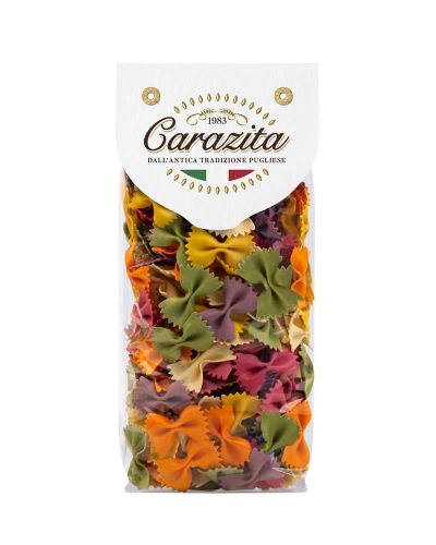 A clear plastic bag of Carazita brand multicolor bowtie pasta (farfalle) with a white paper header label, set against a plain white background.