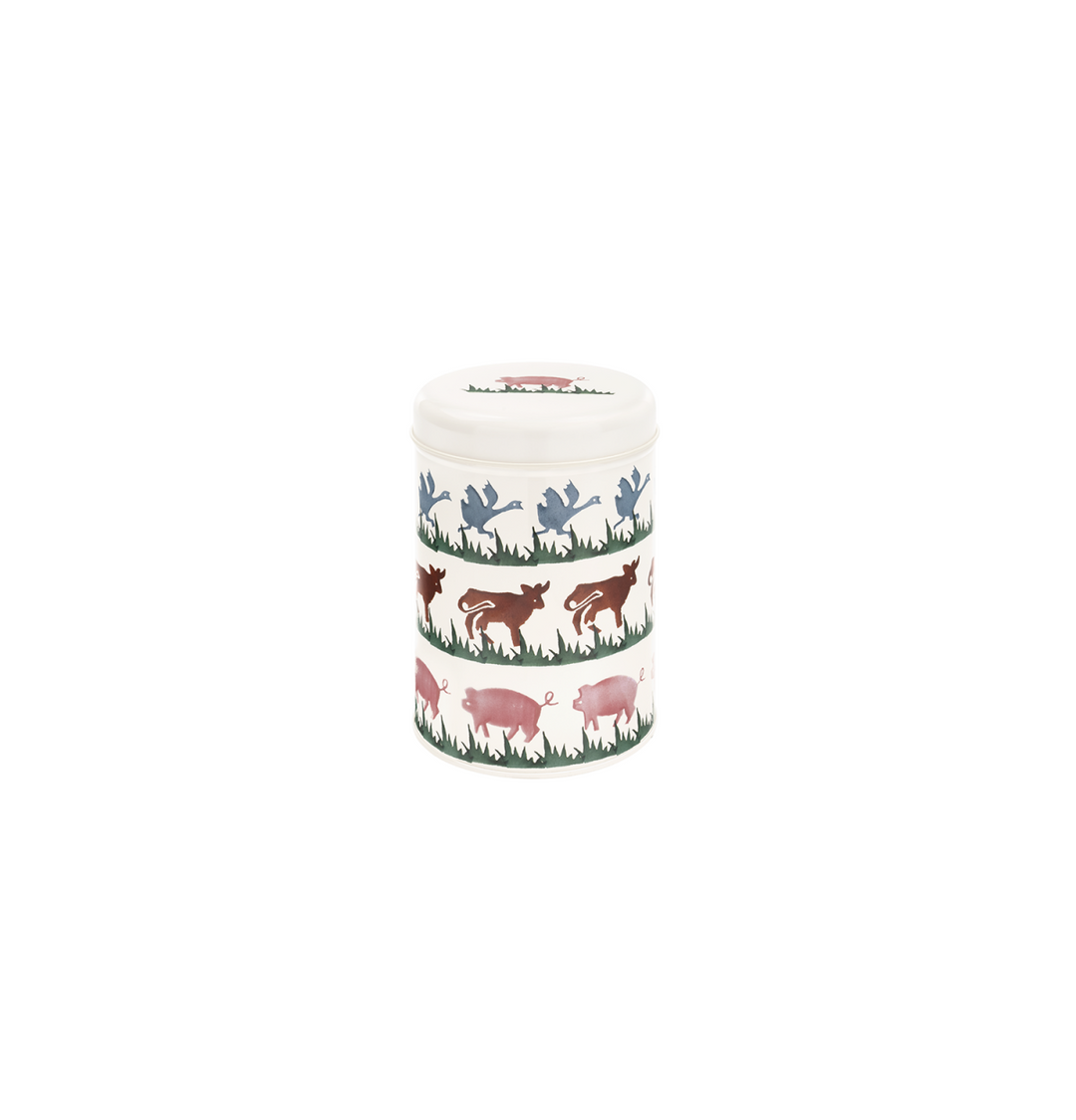 A metal cylinder tin with a pattern of pink pigs, blue birds &amp; brown cows on it