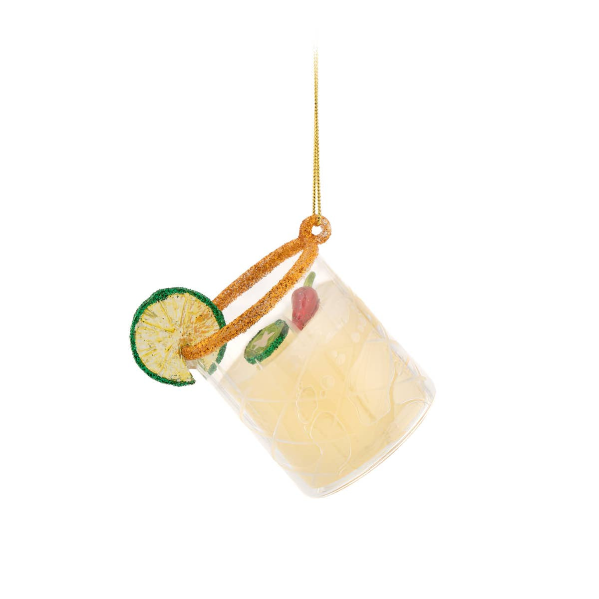 A clear glass tumbler ornament shaped like a cocktail glass with a pale yellow drink, a green lime wheel garnish, a green jalapeño slice, and a red chili pepper, hanging from an orange glittery cord on a white background.