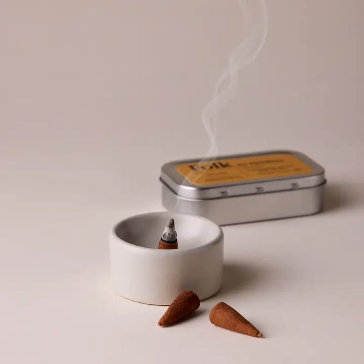 Incense cones and a tin labeled &