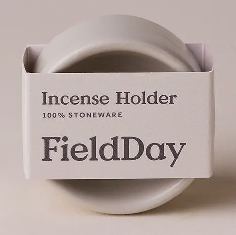 White stoneware incense holder in FieldDay packaging on a beige background
