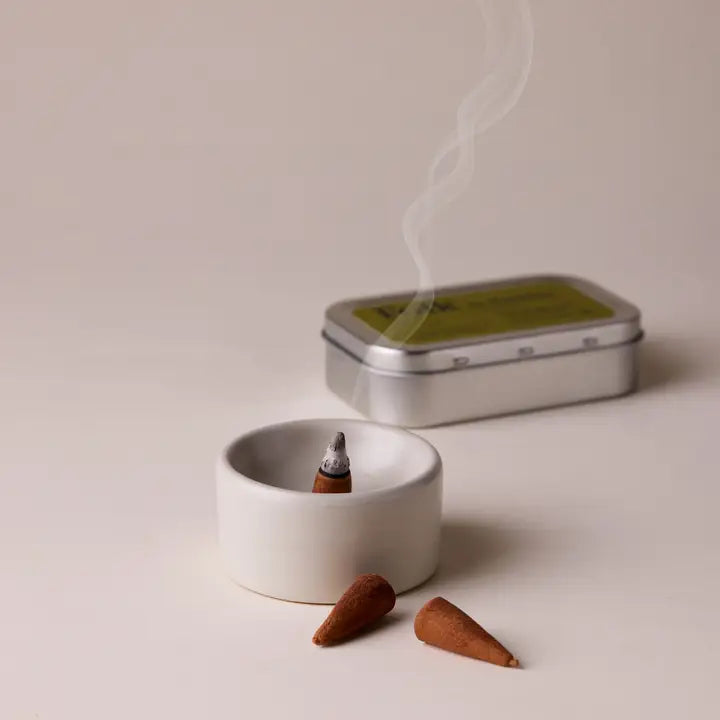 Incense cones and a tin on a light background