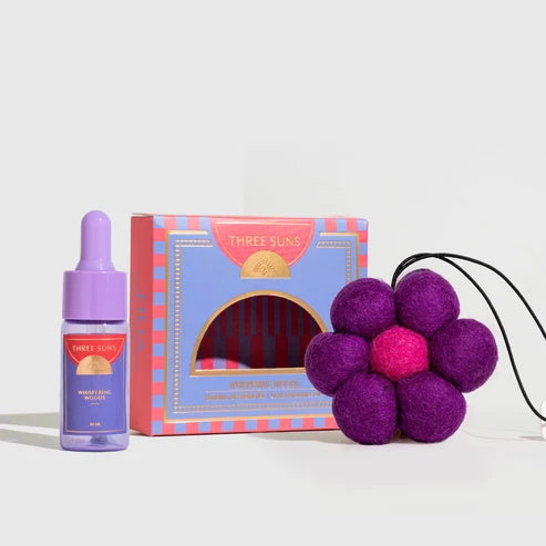 A bottle, box &amp; felt flower freshener on a white background