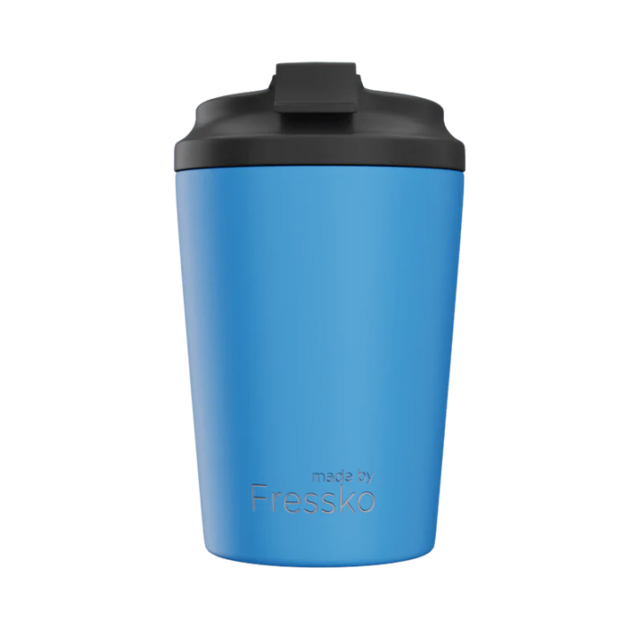 Blue tumbler with black lid on a white background