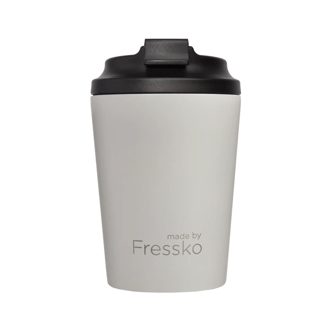 A white travel cup with black lid on a white background