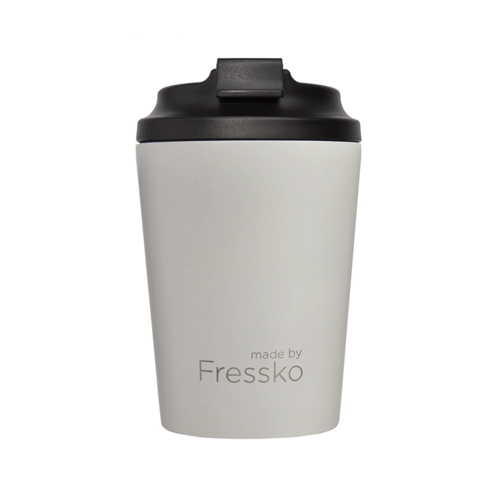 A white travel cup with black lid on a white background