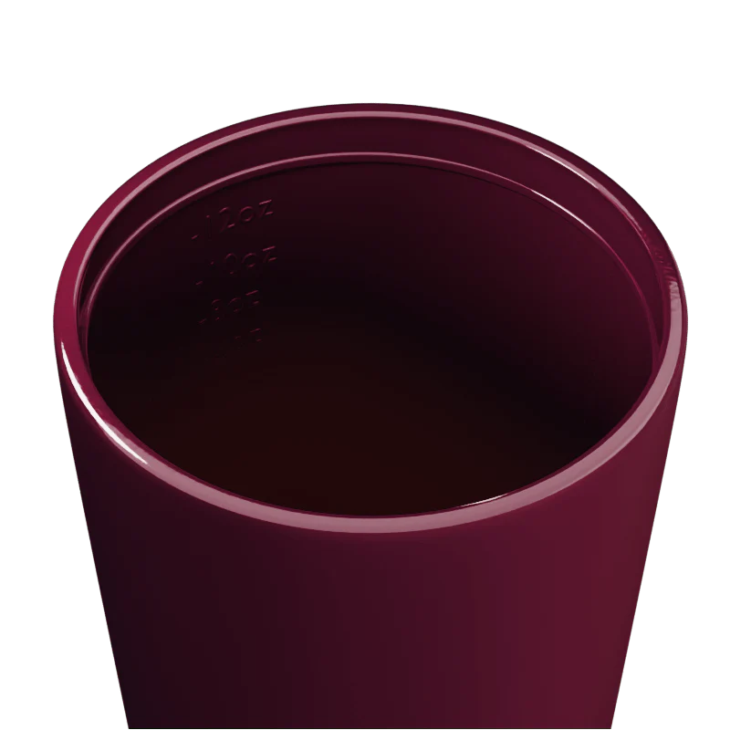 Inside of a Maroon travel cup on a white background