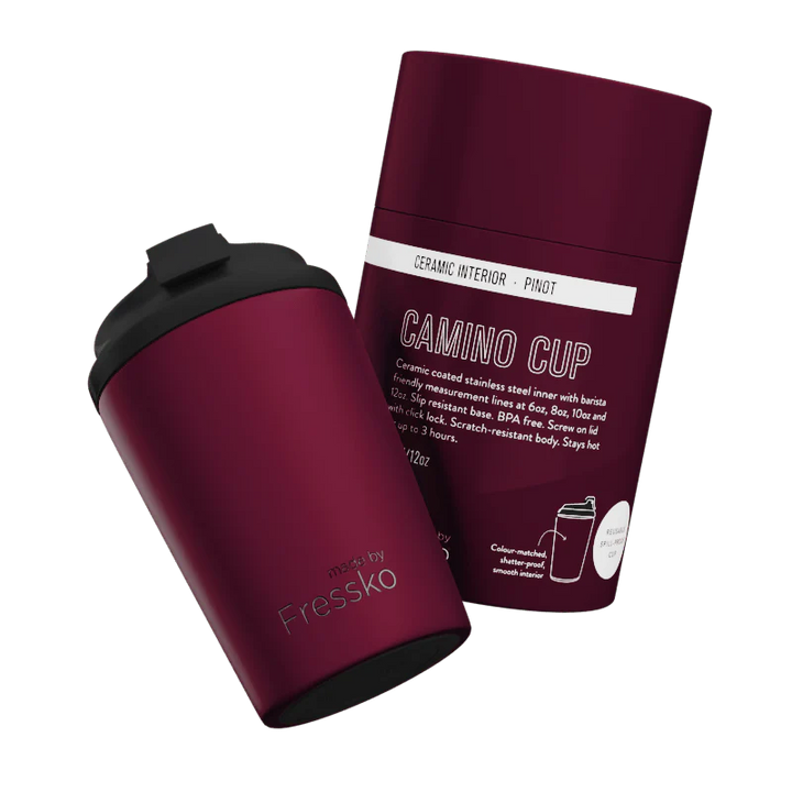 Maroon travel mug with black lid and packaging on a white background