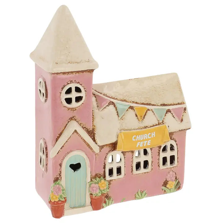 Pink church tealight holder with a steeple and 'Church Fete' sign on a white background