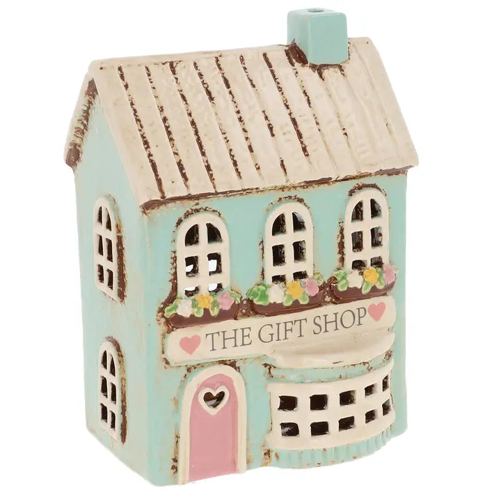 Decorative miniature house tealight holder with 'The Gift Shop' sign on a white background