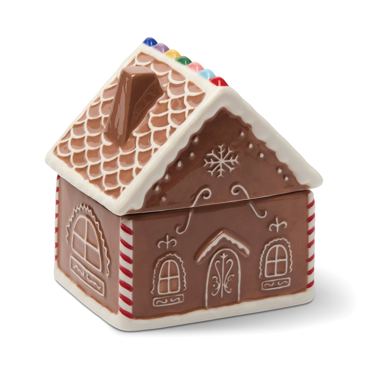 Gingerbread house-shaped candle with a white background