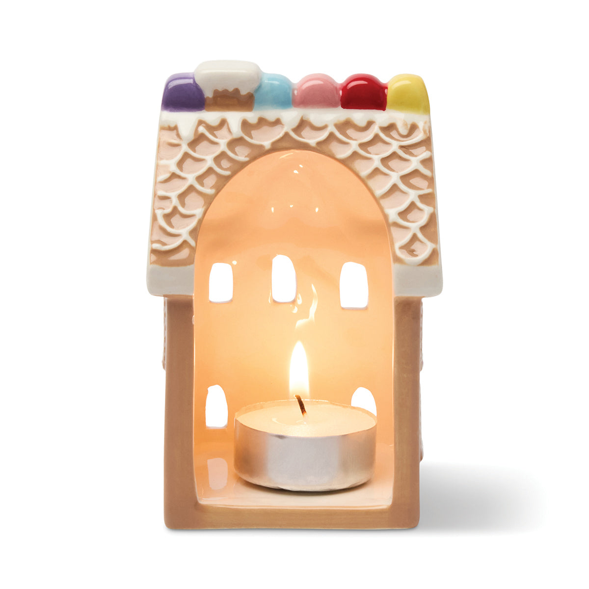 Gingerbread house shaped tea light holder with burning tea light candle on a white background