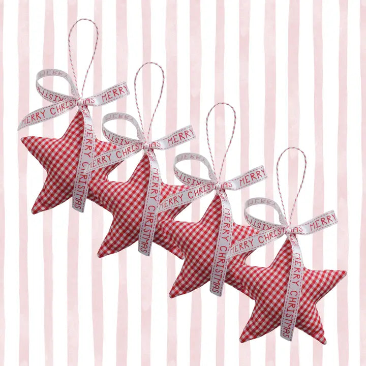 Four red and white gingham star-shaped Christmas ornaments hanging in a diagonal row, each tied with a white ribbon printed with &