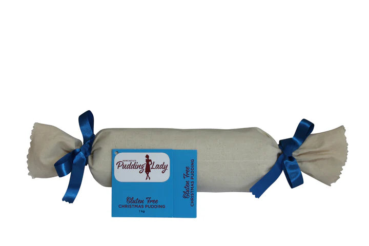 A christmas pudding log wrapped in calico with blue ribbon a white background