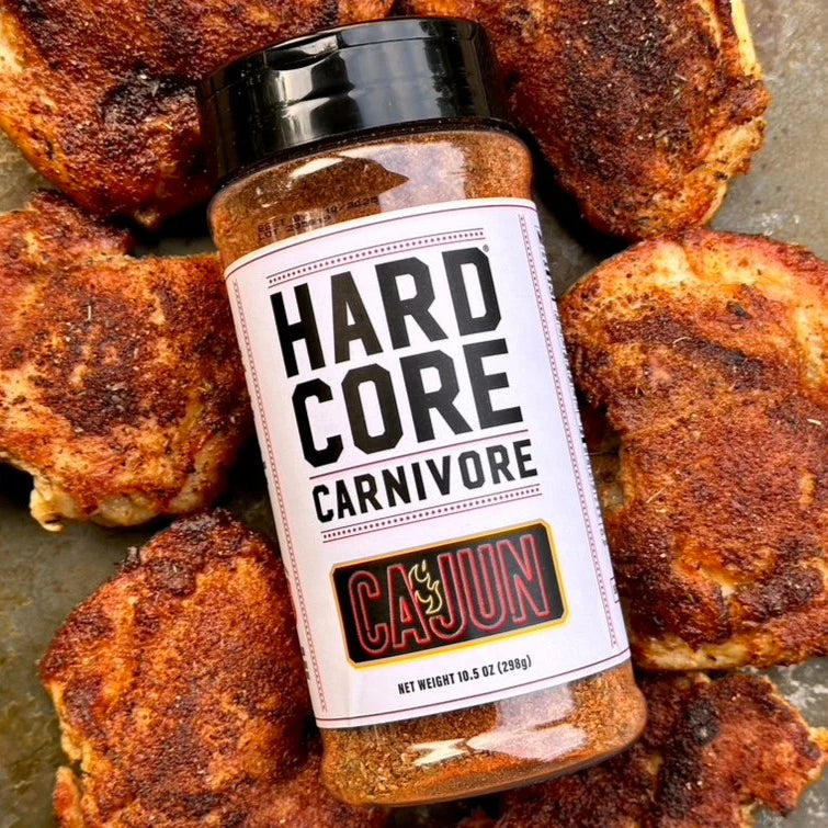 Hardcore Carnivore bottle with chicken thighs that are coated in the cajun spice blend 