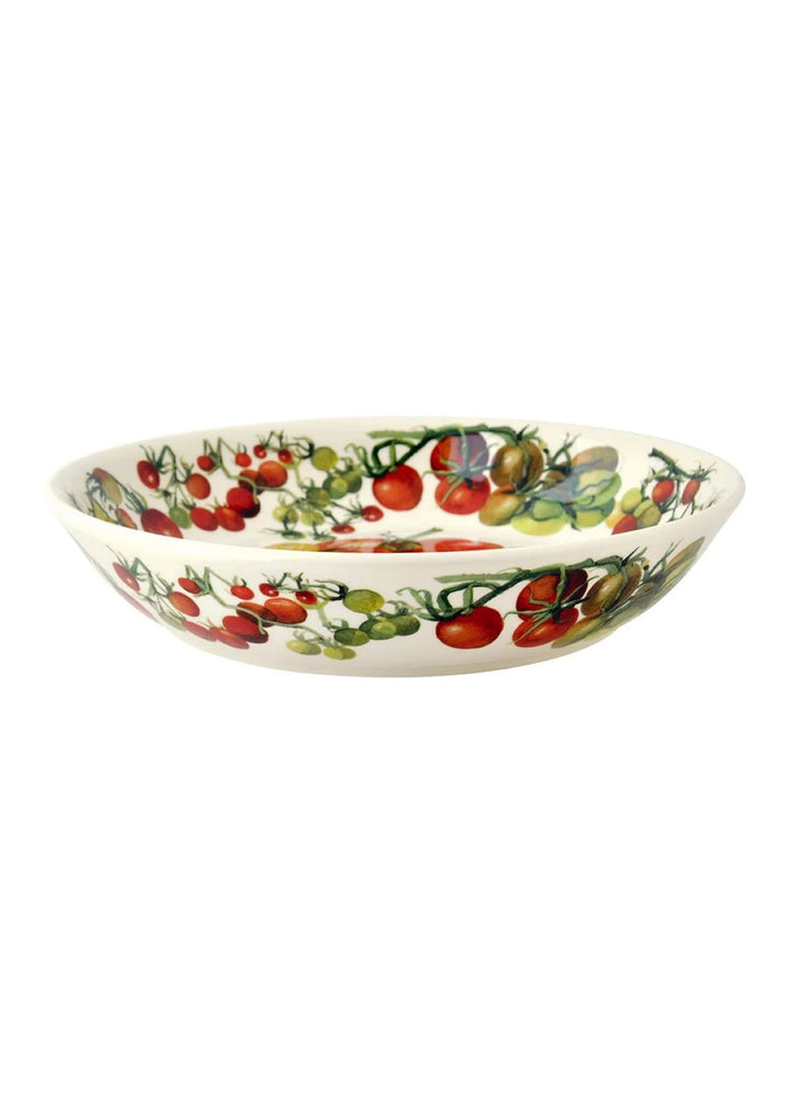 A white ceramic bowl decorated with a colorful print of tomatoes and other vegetables on the vine, shown against a plain white background.